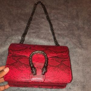 Red snake skin handbag